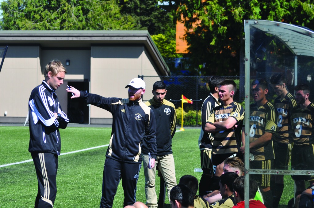 Cale Rodriguez, left, instructs the men's soccer team at the 2015 Rumble in the Rainforest. Photo by Giovanni Roverso