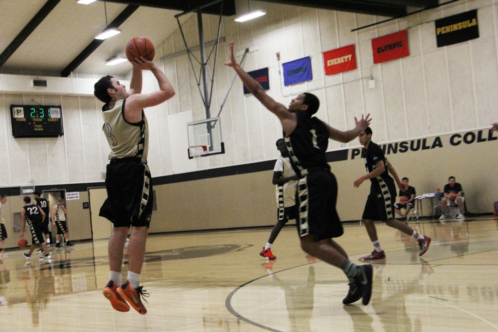 Ryley Callaghan shooting a jumper with Deonte Dixon guarding. - Photo by Eric Trent