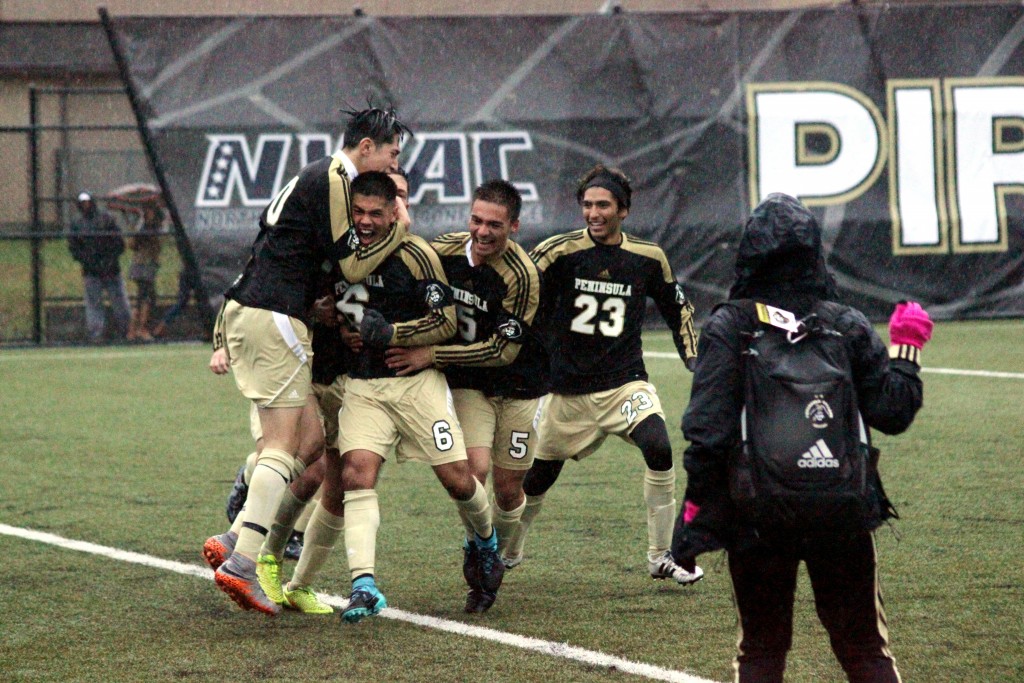 Pirate men celebrate their quarterfinal victory over Walla Walla at Sigmar Field. -Photo by Ivan Sitohang