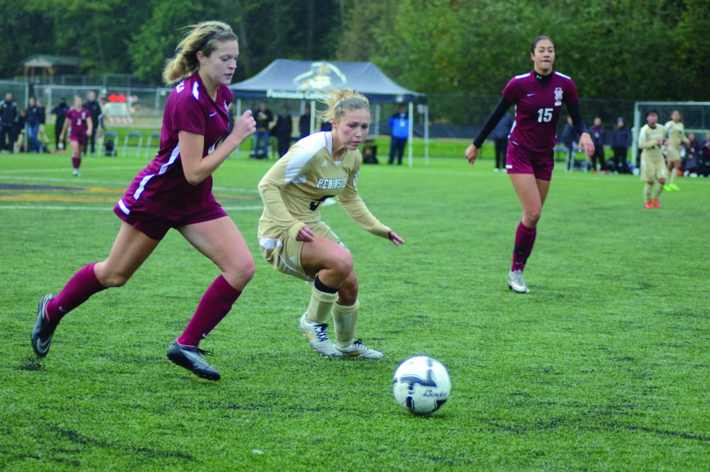 Ellie Small battles a North Idaho defender in the NWAC quarterfinals. -Photo by Judah Breitbach