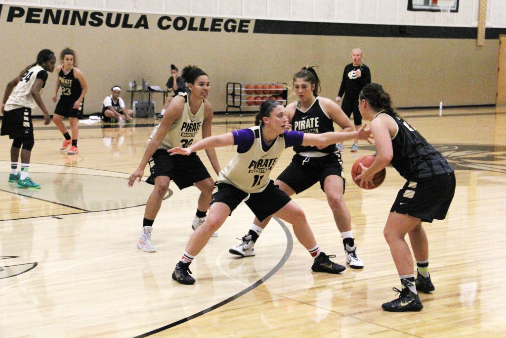 Cierra Moss, middle, guarding her sister Cherish Moss during practice. - Photo by Eric Trent.