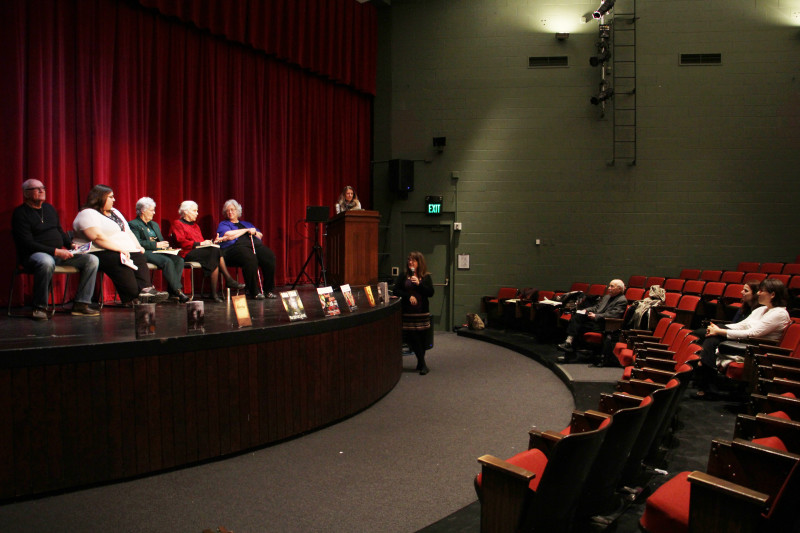 From left: Jim Yerkes, former Buccaneer reporter Sarah Lindquist, Martha Ireland, Eycke Strickland, Melissa Penic, English Instructor Kate Reavey, at podium, co-director of the Foothills Writers Series; Janet Lucas, with microphone. Multimedia Communications Instructor Marina Shipova is seated second from right.
