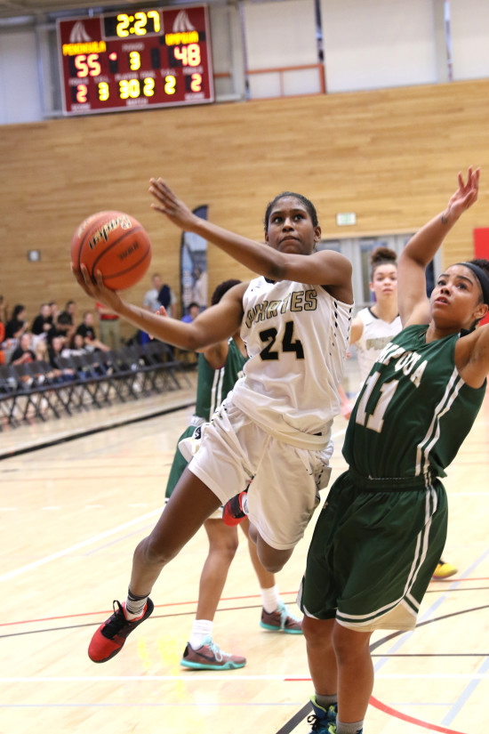 Imani Smith blows by an Umpqua defender for two points in the 2nd half of the quarterfinals.