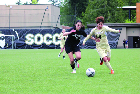 Myu Ban fights for possession with a Saint Martin's player in the 2016 Rumble in the Rainforest, April 23, at Sigmar Field in Port Angeles.