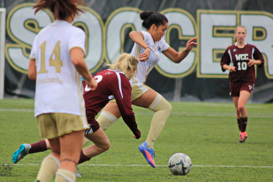 Hoku Afong splits defenders and sprints toward the goal vs Whatcom. - Photo by Ivan Sitohang