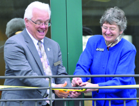 The grand opening of Peninsula College’s Port Townsend campus located in Fort Worden State Park. Peninsula College President Luke Robins (left) laughes as Board of Trustees Chair Julie McCulloch celebrates this monumental event. - Photo by Mike Drake