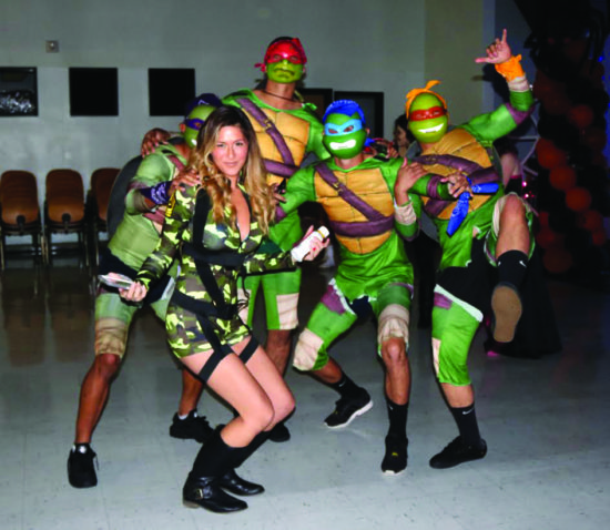 Alicia Beck posing with the Teenage Mutant Ninja Turtles! - Photo by Maria Theresa Binando