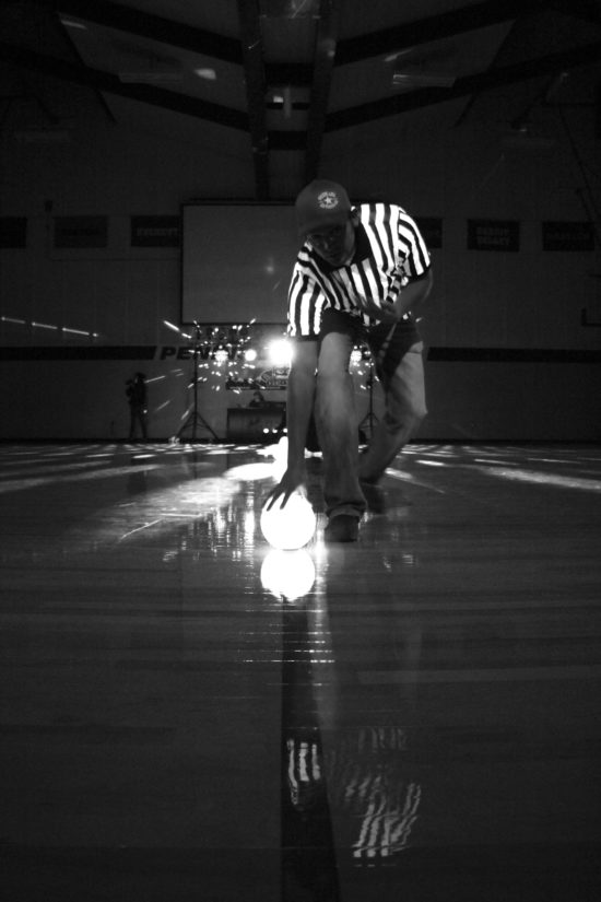 Peninsula College Athletics Activities Coordinator Jeremiah Johnson lines up dodgeballs before the 2016 Black Light Dodgeball tournament. - Photo by Giovanni Roverso