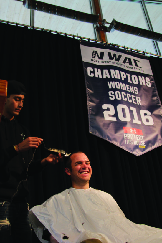 Head Coach Kanyon Anderson fulfilling his promise to the soccer team. - Photo by Ivan Sitohang