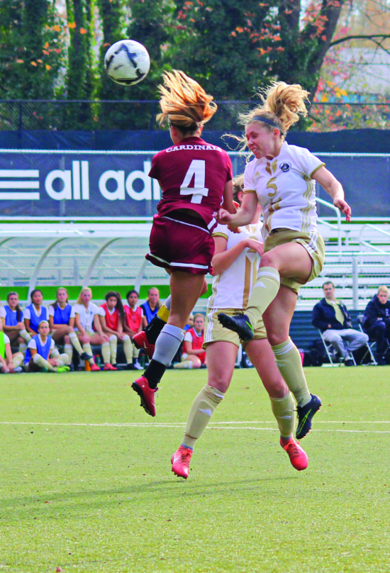 Eleanor Small (right) battles Emily Aspden in the air for possesion of the ball. - Photo by Ivan Sitohang